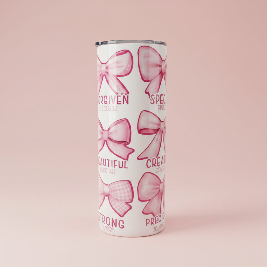 Tumbler with pink bows and text on a white background