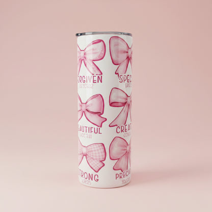 Tumbler with pink bows and text on a white background