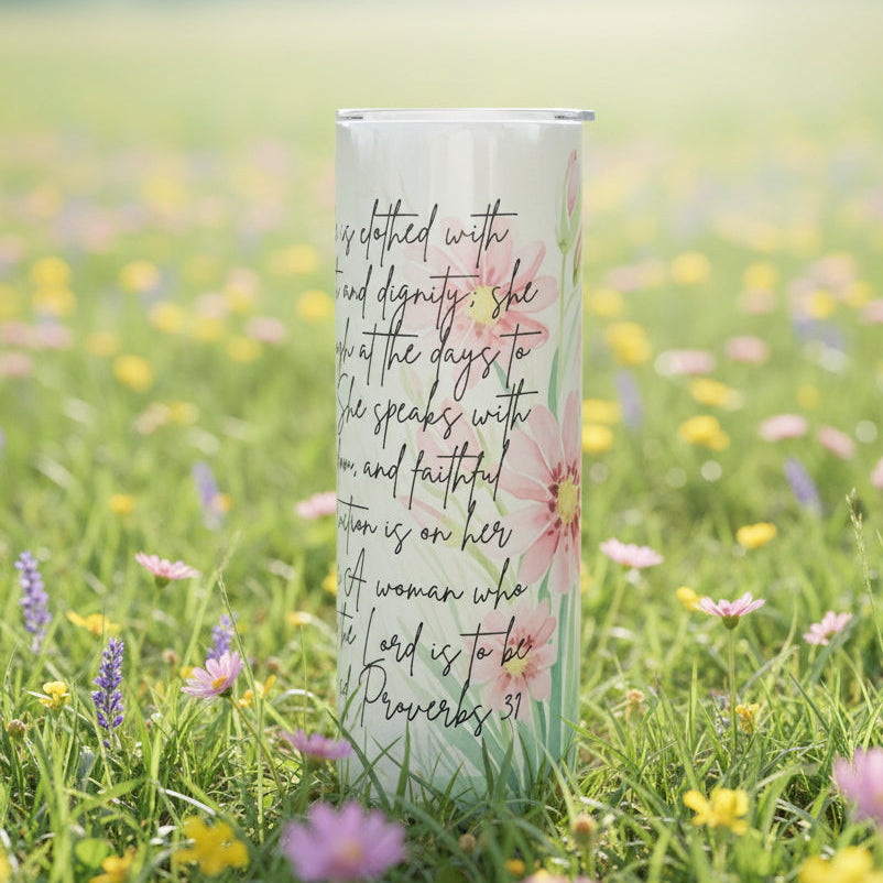 Two tumblers with floral designs and text on a background of grass and flowers