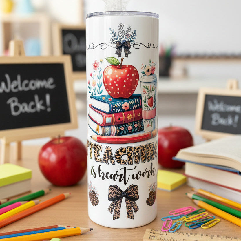 Three insulated tumblers with colorful designs on a black surface.