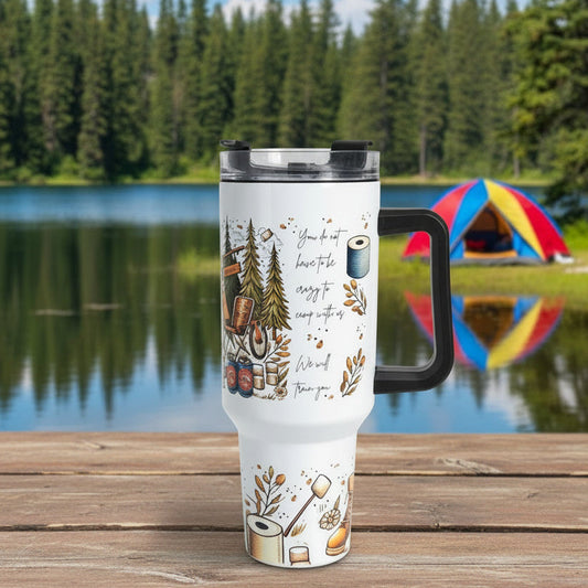 Travel mug with nature-themed design and text on a wooden surface