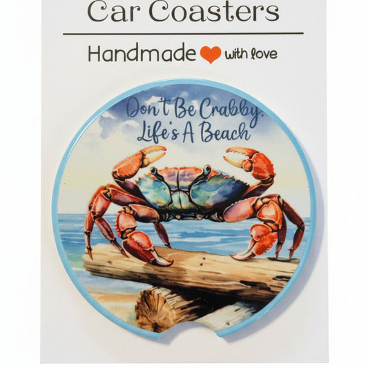 Car coaster with crab design and text on a dark background