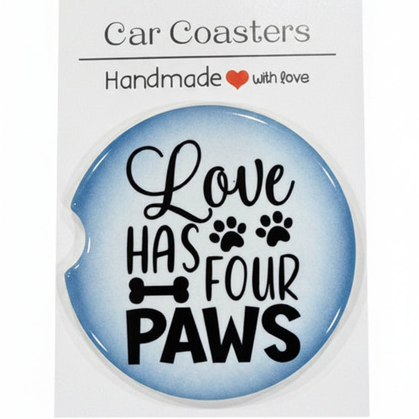 Car coaster with 'Love has four paws' text on a wooden surface