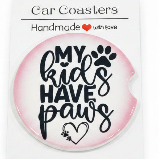 Car coaster with text 'My kids have paw' on a white card, placed on a wooden surface.