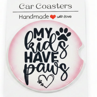 Car coaster with text 'My kids have paw' on a white card, placed on a wooden surface.