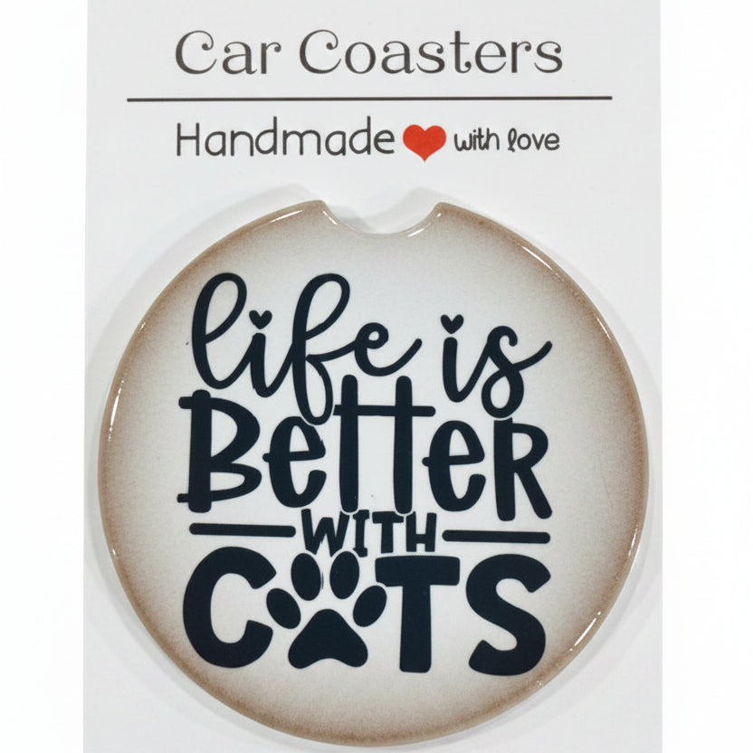 Car coaster with 'Life is better with cats' text on a white card, placed on a wooden surface.