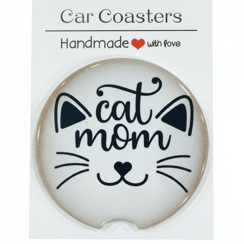 Car coaster with 'cat mom' design on a white card, placed on a wooden surface.