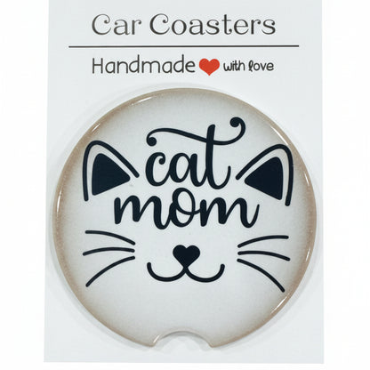 Car coaster with 'cat mom' design on a white card, placed on a wooden surface.