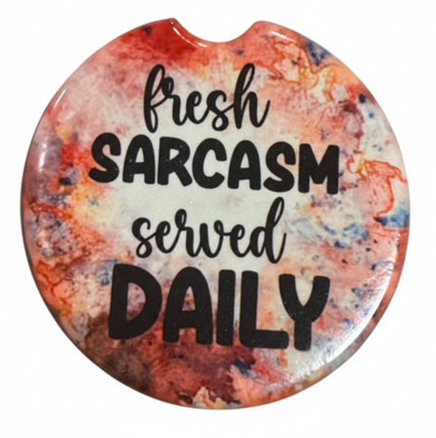 Set of five colorful car coasters with sarcastic sayings on a white background