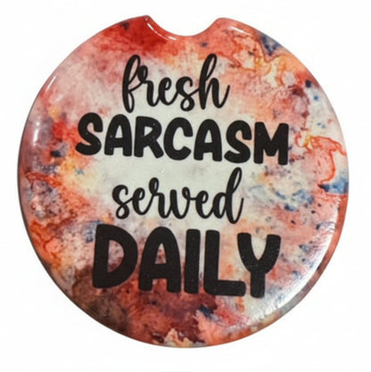 Set of five colorful car coasters with sarcastic sayings on a white background