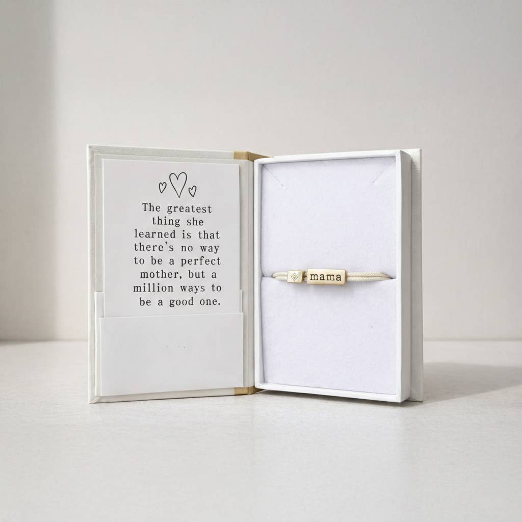 Gold 'mama' necklace in a box with a quote about motherhood.