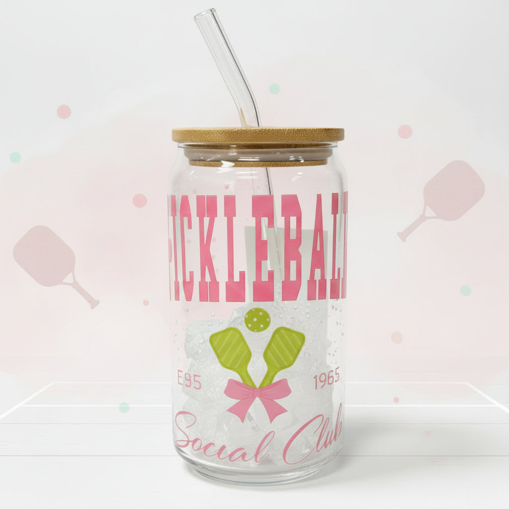 Tumbler with wooden lid and straw featuring a design and text on a white background